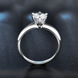 Classic six-prong moissanite solitaire ring in 925 sterling silver on leather background