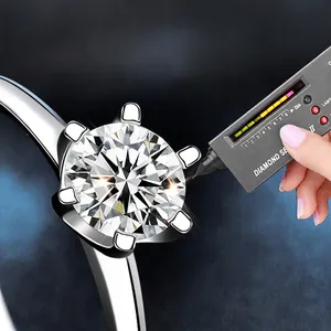Classic six-prong moissanite ring in 925 sterling silver passing a diamond tester