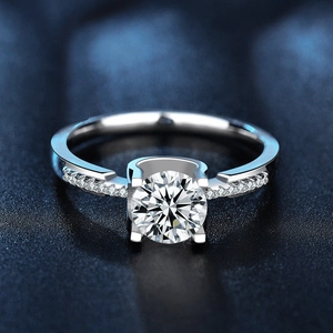 925 sterling silver moissanite ring featuring a classic four-prong setting and pavé band