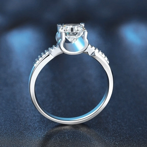 925 sterling silver moissanite ring featuring a classic four-prong setting on blue background