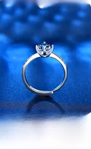 Macro detail of S925 sterling silver ring with blue moissanite and pave zircon accents