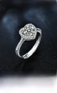 Detailed view of heart-shaped halo moissanite ring with a diamond-set silver band