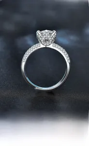 Detailed close-up of a 925 sterling silver lotus ring with six-prong moissanite setting