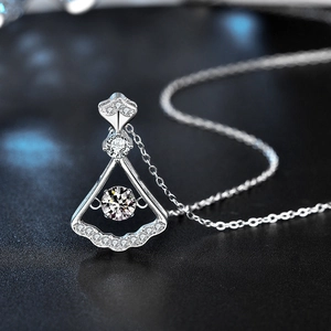 925 sterling silver fan shaped necklace with shimmering moissanite pendant on a dark base