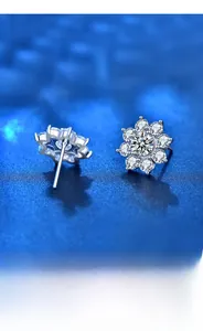 Macro detail of 925 silver sunflower stud earrings with sparkling moissanite stones