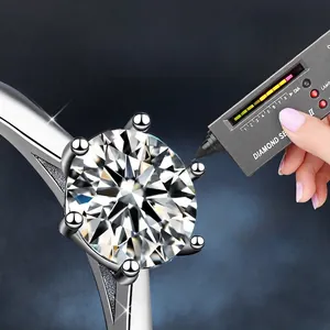6-prong round brilliant cut moissanite ring being tested with a diamond selector tool