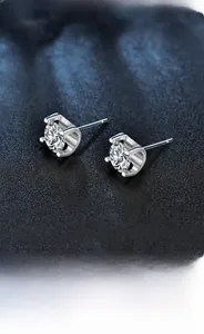 Macro shot of S925 sterling silver stud earrings with round moissanite in four-prong setting
