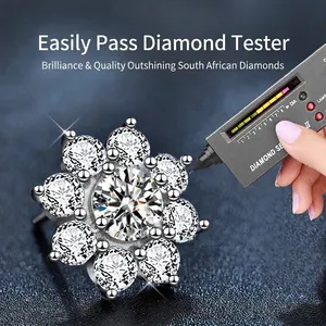 Sunflower Moissanite stud earrings in 925 sterling silver being tested with a diamond tester