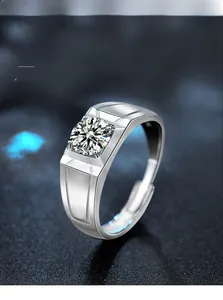 Macro detail of men's wide silver ring with four-prong set round moissanite diamond