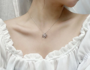Close-up of S925 sterling silver star pendant necklace with moissanite on a model