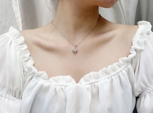 Detail of S925 sterling silver four-leaf clover moissanite necklace worn by a model