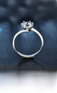 Macro shot of 925 sterling silver six-prong moissanite ring with polished twisted band