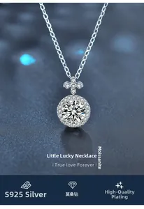 Close-up of S925 sterling silver clover necklace with moissanite pendant on blue background