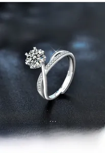 Detail of Moissanite ring featuring a six-prong setting and pavé-set intertwined band