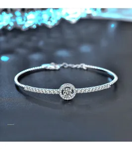Macro view of sterling silver bracelet with moissanite center stone and halo setting