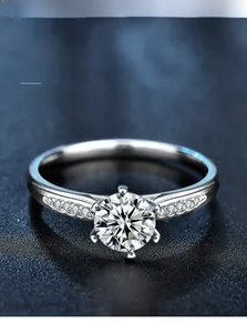 Macro view of six-prong sterling silver ring with 3EX round cut moissanite diamond