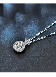 Detailed macro of a Moissanite halo pendant necklace crafted in 925 sterling silver