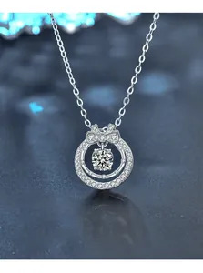 Macro shot of 925 silver double-layer necklace with bow pendant and moissanite stone