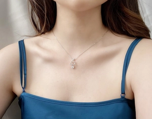 Detail view of a 925 silver Christmas tree necklace with a sparkling moissanite stone