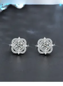 Detailed macro view of 925 silver clover earrings with high-grade Moissanite 3EX heart cut