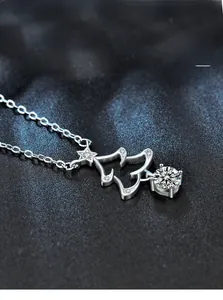 Close-up of 925 sterling silver Christmas tree pendant with moissanite and star detail