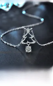 Macro detail of 925 sterling silver Christmas tree pendant with sparkling moissanite stones