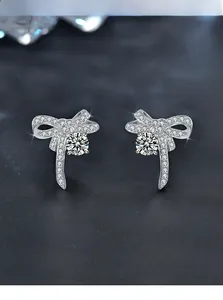 Detail of bow earrings with 3EX 58-facet cut stones and hearts and arrows pattern