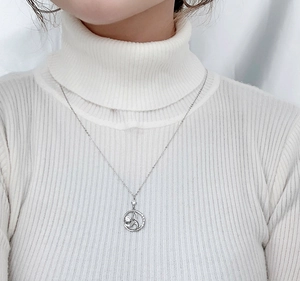 Detail of 925 sterling silver mermaid bubble necklace on a white sweater background
