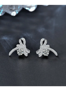 Detailed close-up of bow earrings with sparkling moissanite stones and S925 silver finish