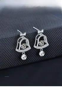 Macro shot of 925 sterling silver Christmas bell earrings with 3EX cut moissanite stones