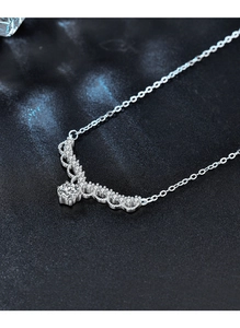 Macro close-up of sterling silver deer antler crown pendant with Moissanite stone