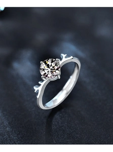 Macro shot of silver deer antler ring featuring a sparkling moissanite center stone