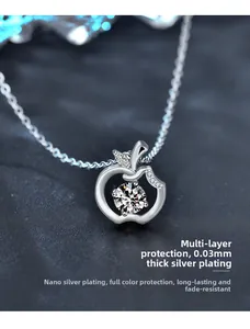 Close-up of 925 sterling silver apple pendant necklace with sparkling moissanite stone