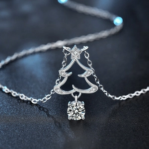 925 silver Christmas tree necklace with sparkling moissanite pendant on dark background
