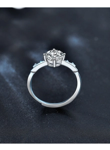 Macro view of adjustable 925 silver reindeer ring with moissanite and blue side stones
