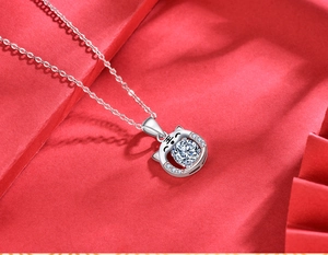Macro shot of 925 silver tiger pendant with a moissanite stone and detailed engraving
