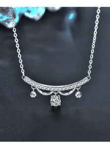 Close-up of S925 silver lace necklace with pavé bar, bell charms and moissanite pendant