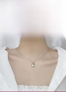 Detailed close-up of a 925 sterling silver tiger necklace with a round moissanite pendant