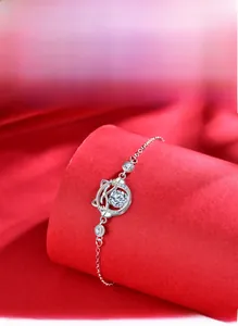 Close-up of 925 sterling silver cat bracelet with 58-facet moissanite on red silk