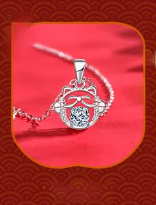 Macro view of S925 silver lucky cat pendant with sparkling center stone on red silk