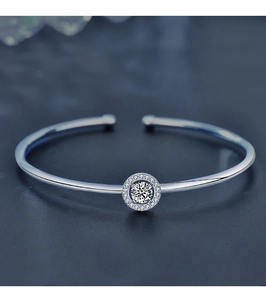 Macro shot of 925 sterling silver open bracelet with Moissanite stone and halo diamonds