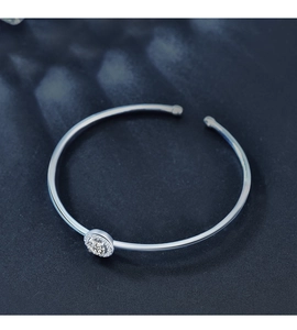 Close-up of S925 sterling silver open bangle with round moissanite and halo stones