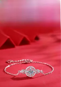Macro shot of 925 sterling silver coin bracelet with moissanite center on red background