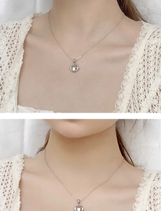 Detail of 925 sterling silver necklace featuring a round moissanite pendant on a fine chain