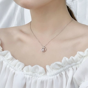 Elegant 925 sterling silver apple pendant necklace with Moissanite stone on a model