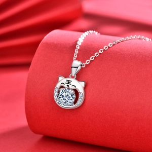 925 silver tiger necklace with round moissanite stone on festive red pedestal