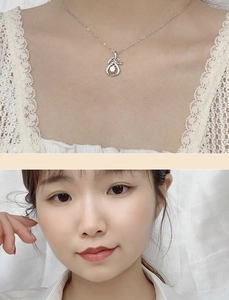 Dettaglio di una collana in argento sterling 925 con ciondolo a fiocco su una modella