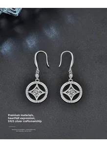 Detailed macro view of S925 sterling silver earrings with star-set moissanite and hook