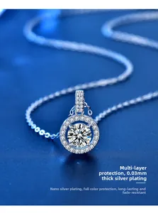 Macro shot of silver round moissanite pendant with four-prong setting on blue background
