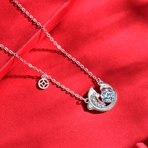925 silver necklace with double dolphin pendant and round moissanite on red background